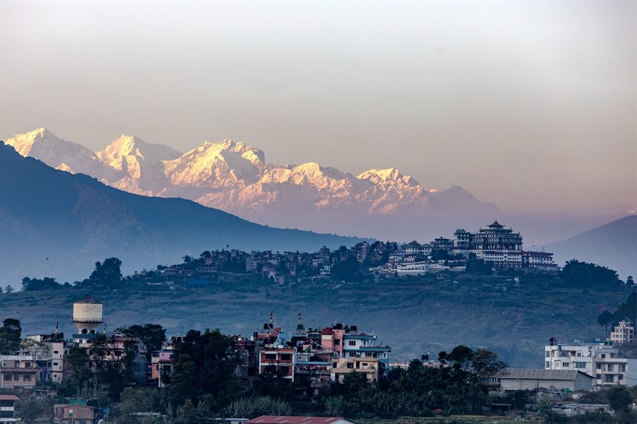 Town below snow-capped Himalayan peaks